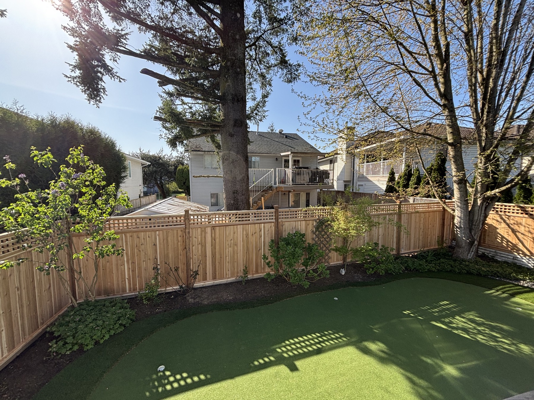 A cedar fence beside turf
