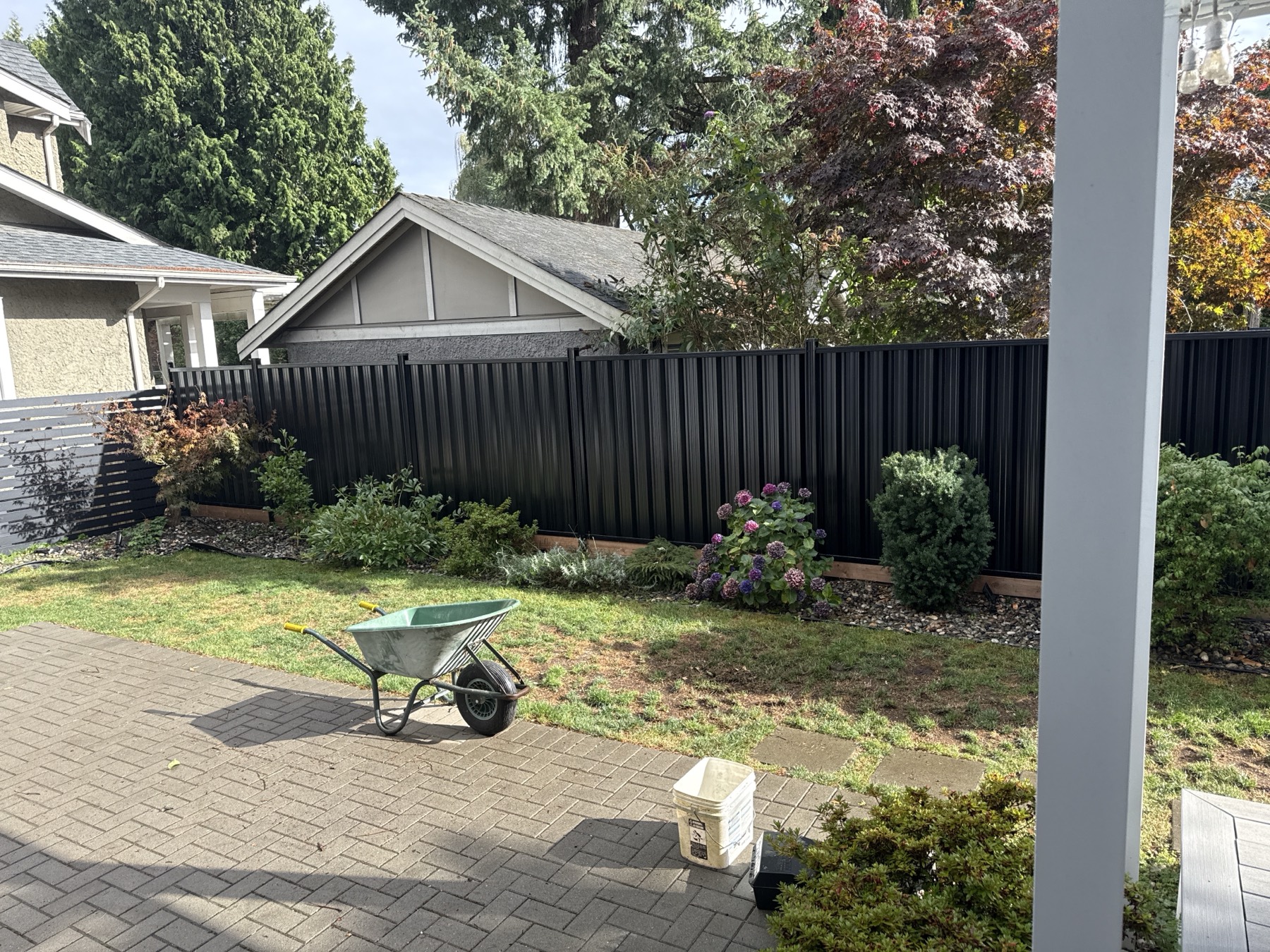 A dark metal fence behind a patio