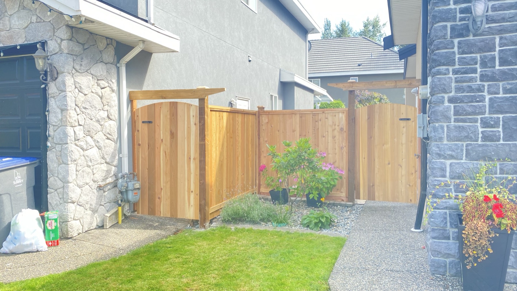 A cedar gate between two houses