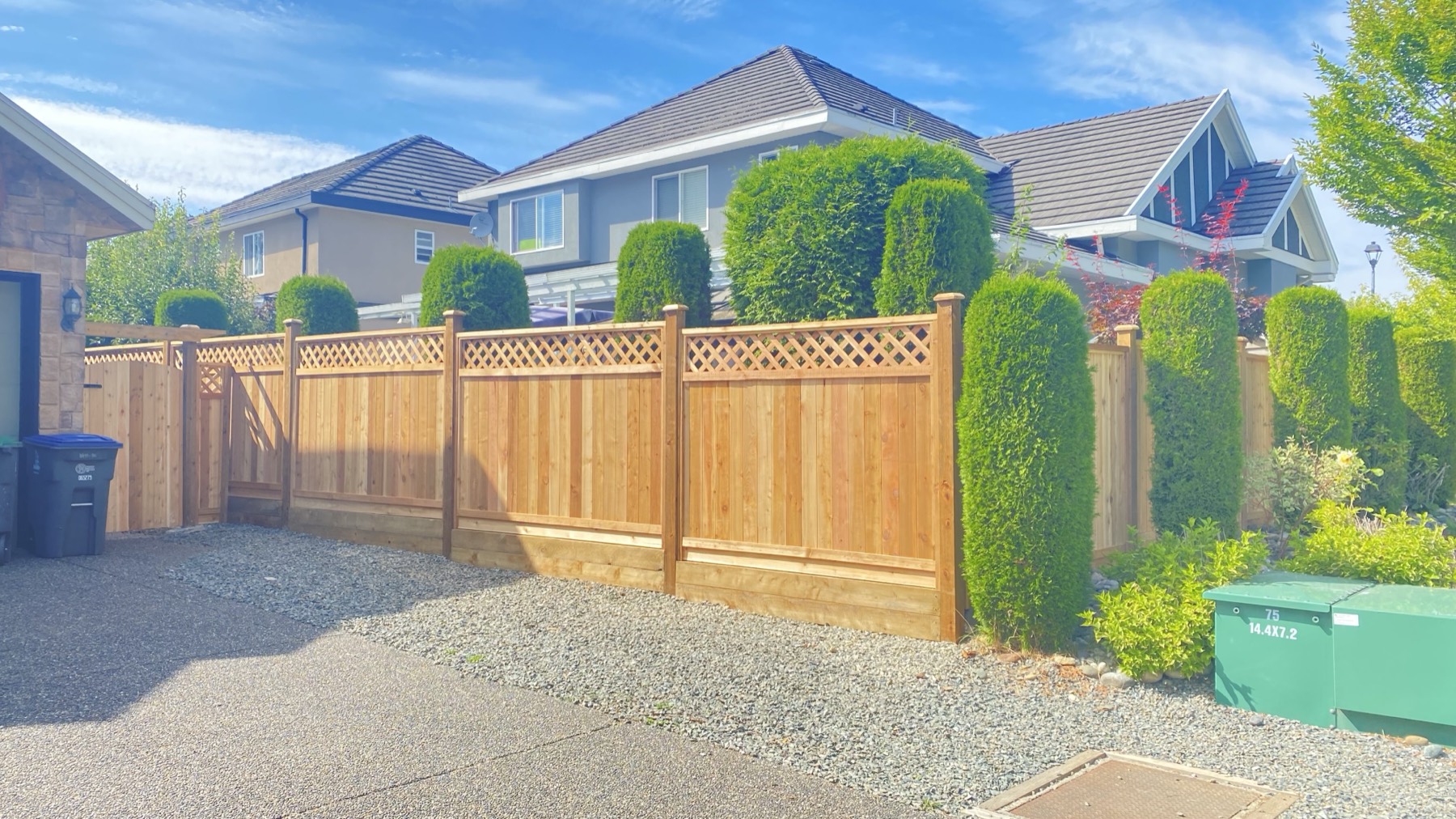 A lattice topped fence and hedging