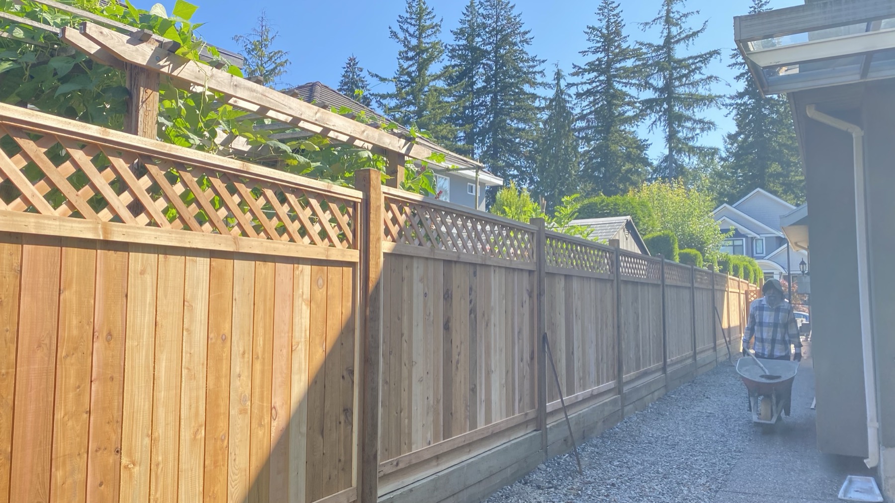 A lattice topped fence beside a carport